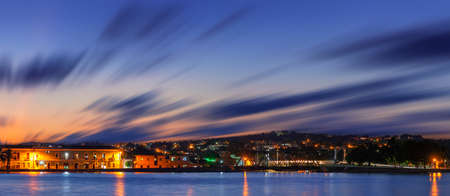 A panoramic view of a long exposure sunset cloudscape over a seaside city Matanzas, Cubaの写真素材