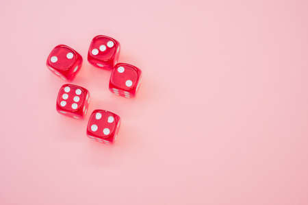 A closeup of red rolling dice on a white backgroundの写真素材