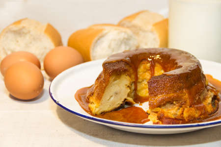 bread pudding made with stale bread, milk, eggs and sugar, decorated with liquid caramel and dulce de lecheの写真素材