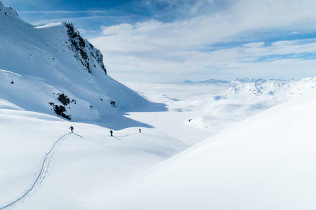 A high angle shot of snowy mountains in winter under the sunlight