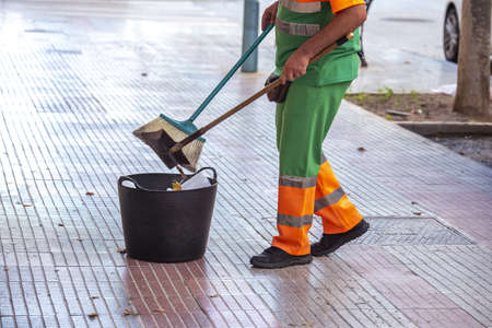A worker sweeping and cleaning the streets of the cityの写真素材