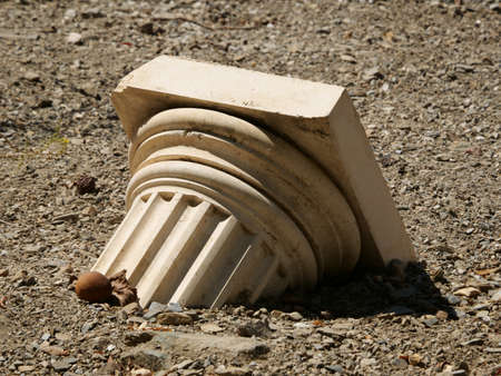 A closeup shot of a broken Greek column on the floor
