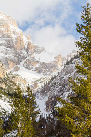 A vertical landscape of mountains covered with snowの写真素材