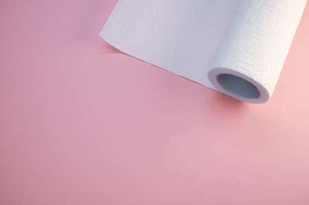 A kitchen paper roll on a pink backgroundの写真素材