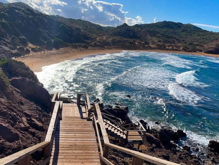 A wooden stairs to wavy seaの写真素材