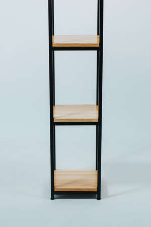A beautiful shot of a wooden modern shelf isolated on a white background