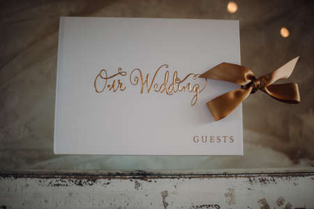 A top view of a guest book for a wedding ceremony on a vintage-style wooden tableの写真素材