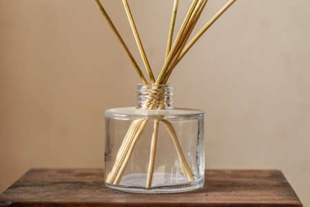 A closeup of scented candles on a wooden stand