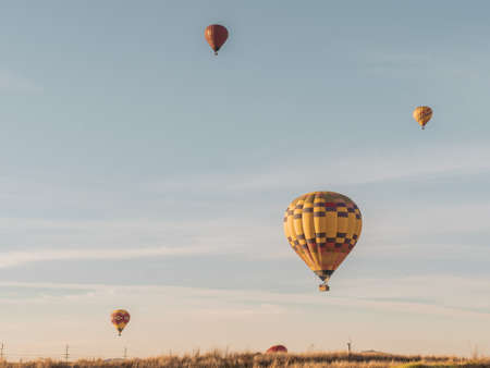 Three parachutes flying up in the air during daytimeの写真素材