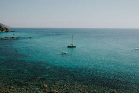 A beautiful view of boats in turquoise water with clear skylineの写真素材