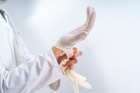 A shot of a doctor's hands wearing glovesの写真素材