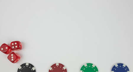 the red dices with white dots and poker chips on a white backgroundの写真素材