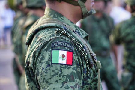 A Mexican soldier with a uniform and a mexican flagの写真素材