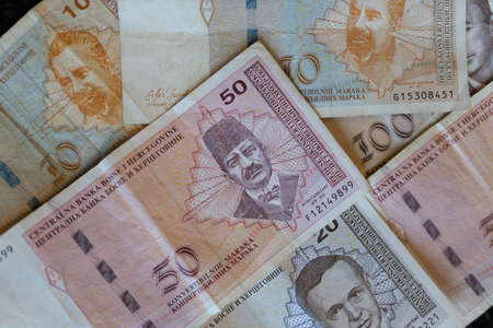 A closeup shot of the banknotes of Bosnia and Herzegovina currency spread on the surfaceの写真素材