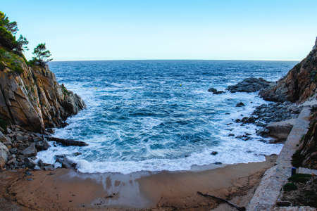The cliffs on the shore of the sea in Tossa de Mar, Spain