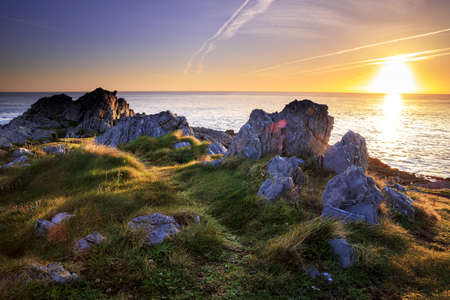 A mesmerizing scenery of a rocky shore during sunset-perfect wallpaper or background
