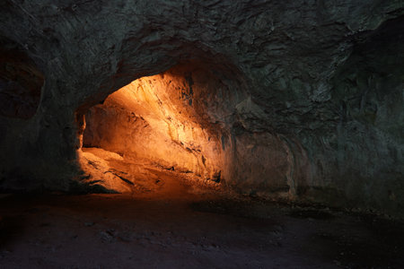 A road leading to a cave with a light in itの写真素材