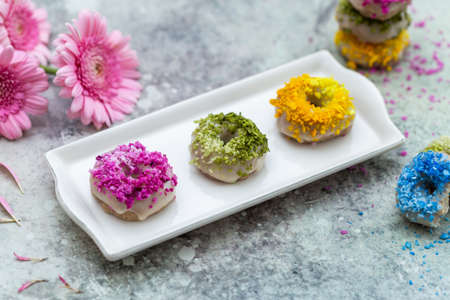A closeup shot of tabletop of vegan raw colorful donutsの写真素材