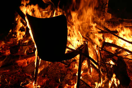 A black chair on fire with everything else burning next to it - horror conceptの写真素材