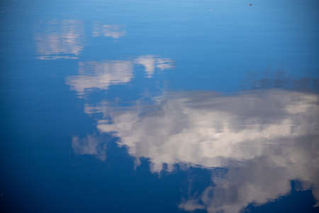 A shot of sky and clouds reflected in the pure waterの写真素材