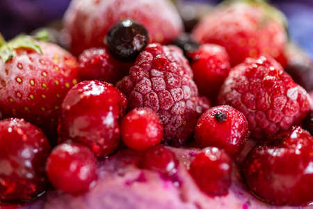 A closeup shot of a fruit shake topped with frozen yummy fruitsの写真素材