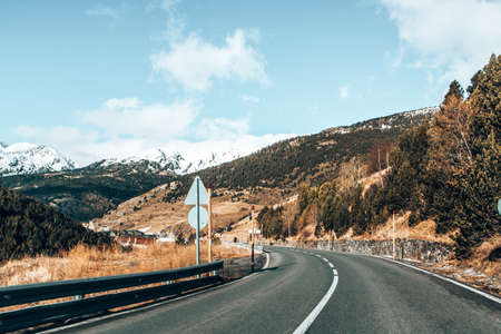 A beautiful shot of road through Andorra mountains and small villagesの写真素材