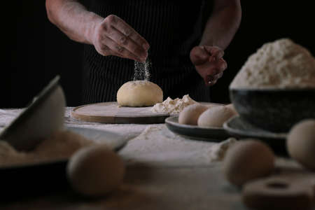 The chef in the process of making a pizza dough