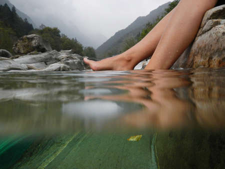 A closeup shot of female bare feet in the riverの写真素材