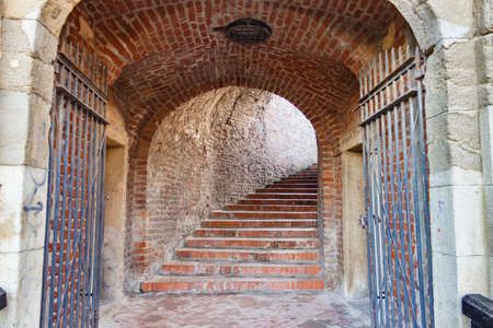 A closeup shot of an old brick arc leading to a staircase
