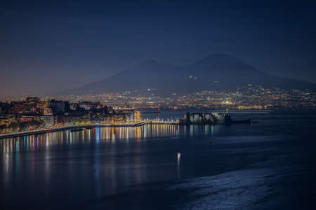 An aerial shot of the sea with Naples night panorama a Vesuvius in Italyの写真素材