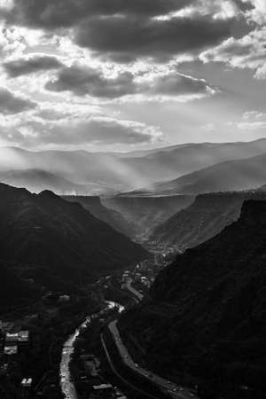 The greyscale shot of the roads through the mountainsの写真素材