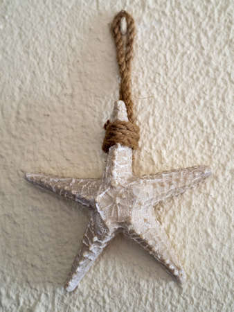 A closeup of a faux starfish decor hanging on the wallの写真素材