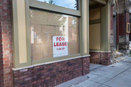 A closeup shot of a For Lease sign in a building window in downtown Morgantown in West Virginiaの写真素材