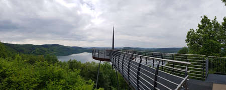 A panoramic shot of Aussichtsplattform Biggeblick in Attendorn, Germany during a gloomy weatherの写真素材