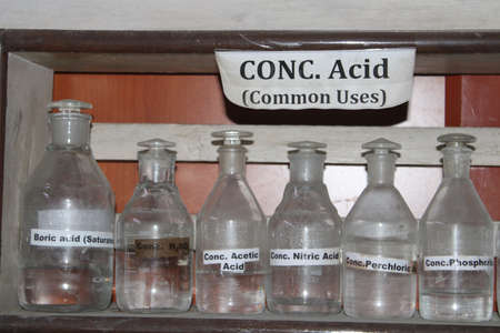 Transparent bottles filled with concentrated acid