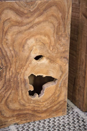 A vertical shot of a wooden surface with abstract holesの写真素材