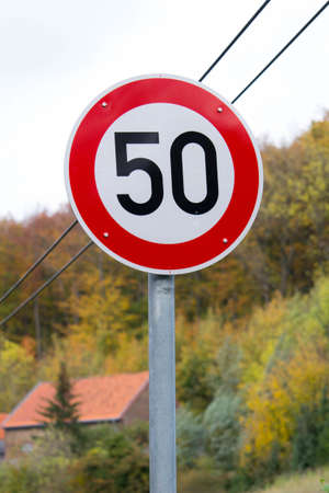 A vertical shot of a speed limit traffic signal at 50km per hourの写真素材