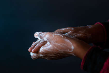 A closeup shot of the soaped hands of a person - importance of washing hands during the coronavirus pandemicの写真素材