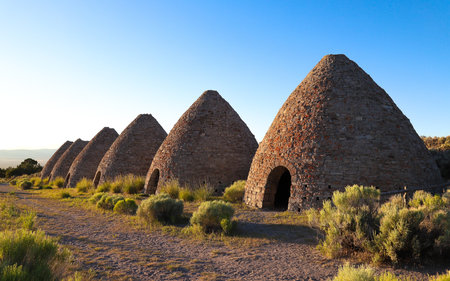 WHITE PINE COUNTY, NEVADA, UNITED STATES - Jun 27, 2018: Ward Charcoal Ovens stand in a line at the rural Ward Charcoal Oven State Historic Park in eastern Nevada.のeditorial素材