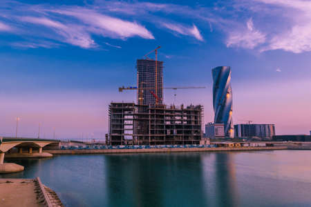 MANAMA, BAHRAIN - Dec 19, 2020: Four seasons hotel and United building/Wyndham Grand hotel at sunrise, Manama, Bahrain.のeditorial素材