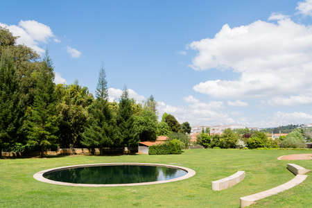 A little pond in the gardens of Quinta das Lagrimas and stone seats in Coimbra, Portugalのeditorial素材