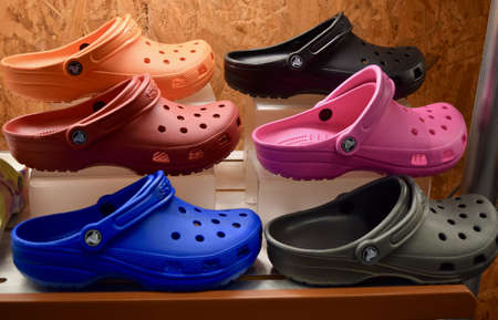 FRESNO, UNITED STATES - Sep 01, 2020: A top photo of 6 Crocs on a store shelf in different colors in...