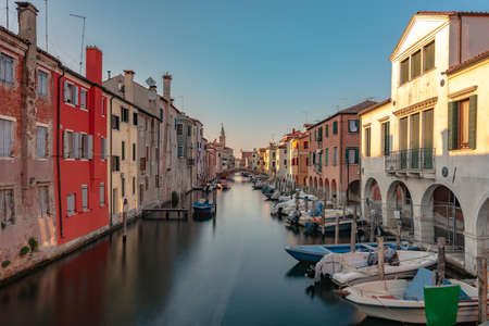 CHIOGGIA, ITALY - Jun 20, 2020: The main canal of the city of Chioggia called Little Venice with its boats reflecting the adjacent buildings and shops on the surfaceのeditorial素材