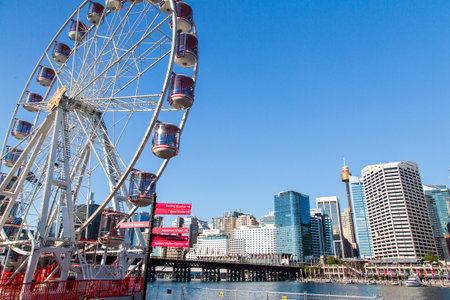 A view of a ferris wheel at the Darling Harbour in Sydney, Australia on a blue sky backgroundのeditorial素材