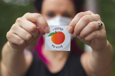 LAWRENCEVILLE, UNITED STATES - Oct 29, 2020: Lawrenceville, GA / United States - October 29 2020: A Georgia voter displays her "I Voted" sticker after voting in the 2020 Presidential Election.のeditorial素材