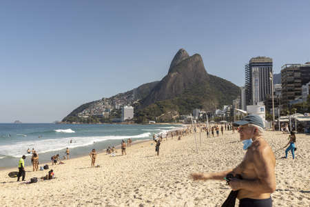RIO DE JANEIRO, BRAZIL - Jul 19, 2020: Reopened Ipanema beach with an elderly man in the foreground...