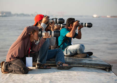 BANJARMASIN, INDONESIA - Feb 14, 2010: A group of photographers is taking picture using their...