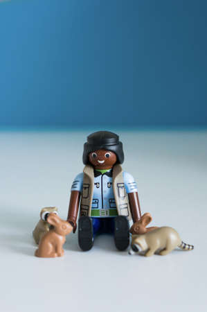 POZNAN, POLAND - Sep 16, 2017: Playmobil female ranger animal friend sitting between raccoons and rabbits in soft focusのeditorial素材