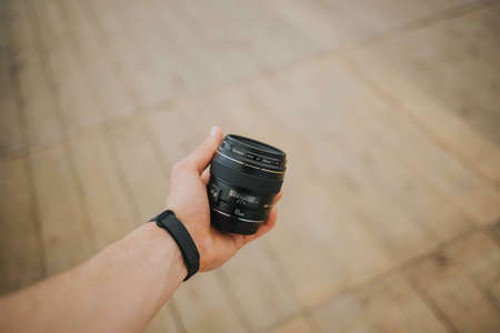 BRC, BOSNIA AND HERZEGOVINA - May 15, 2019: Shot of Canon 85mm prime lens in mans left handのeditorial素材