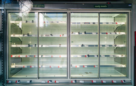 LONDON, UNITED KINGDOM - Apr 08, 2020: Empty fridge shelves at a closed-down shop due to the Coronavirus / Covid19 crisis.のeditorial素材